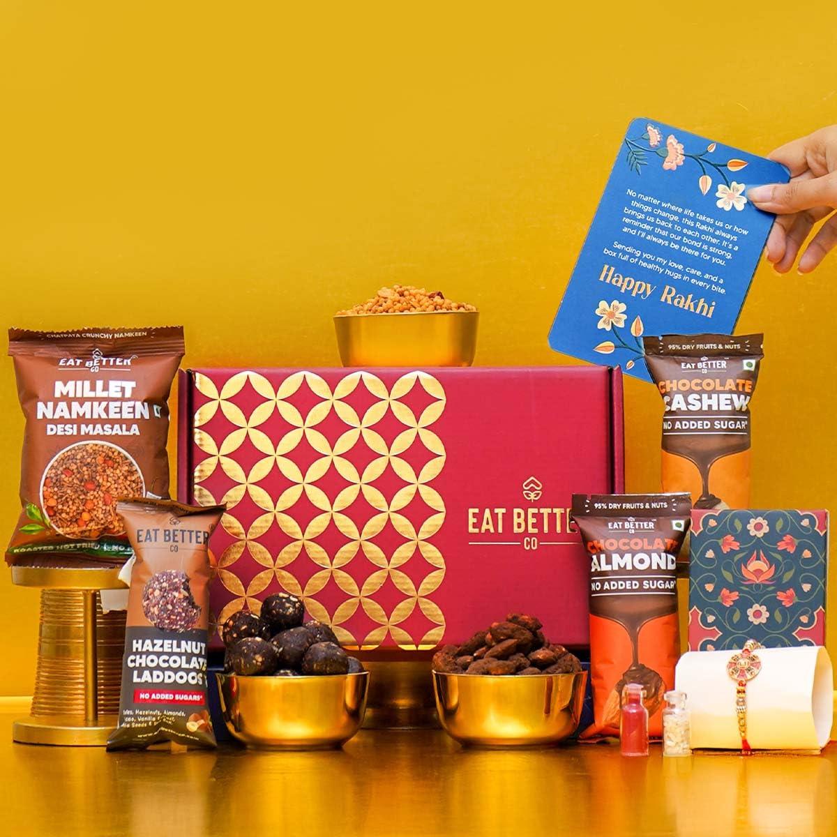 EAT BETTER CO Anmol Rakhi Gift Hamper - 7 Items Combo Pack - Chocolate Coated Almonds & Cashews - Four packets of Dry Fruits with Roli, Chawal & Rakhi | Raksha Bandhan Box for Brother - Rakhi with Gift Set